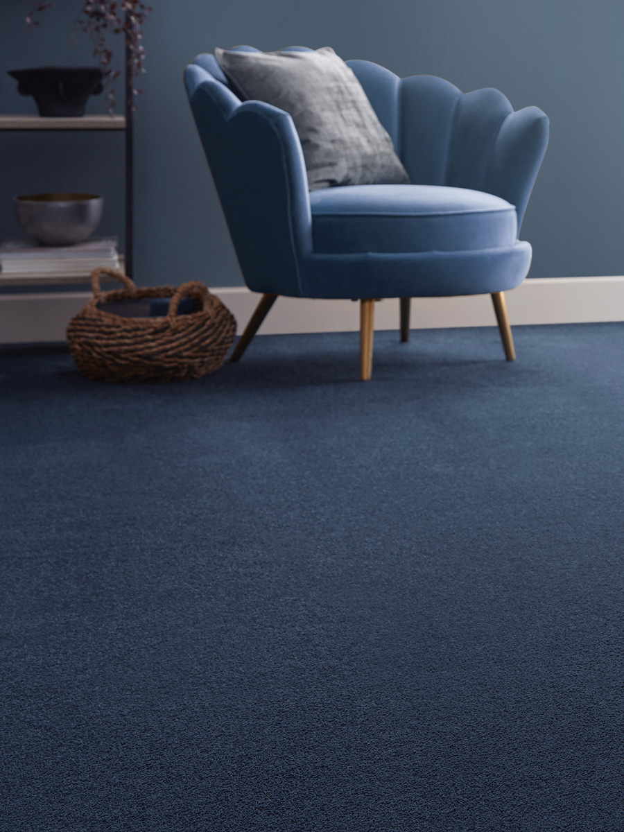 blue velvet armchair with blue carpet